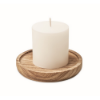 Candle on round wooden base in wood
