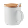 Porcelain mug with spoon in White
