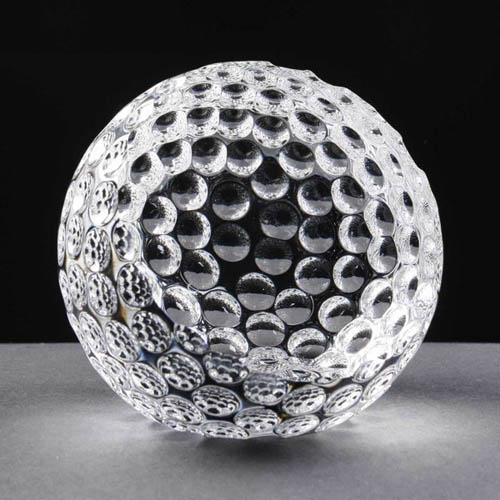 Crystal golf ball with flat face
